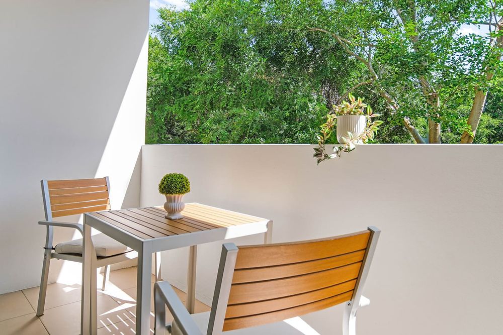 Balcony table and chairs under the trees