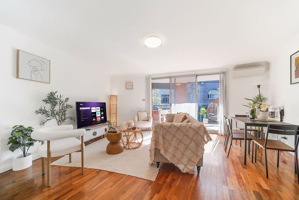 Living room with a sofa, TV and dining table