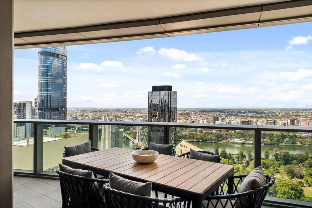 Balcony dining table for six looking over the river and the city